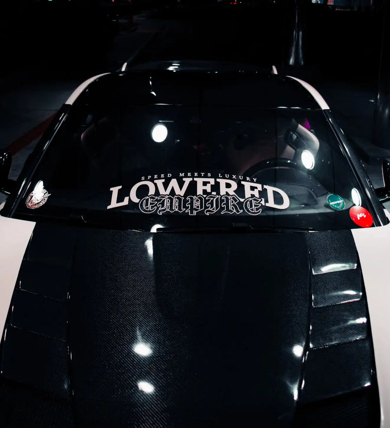 Black carbon fiber car hood with ’lowered’ and ’@alpure’ decals.
